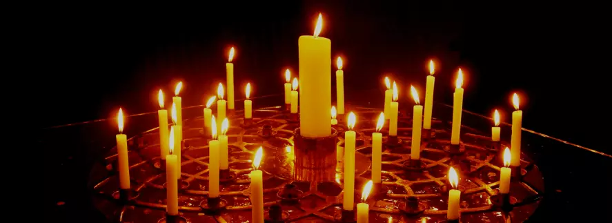 Votive candles shining in the darkness